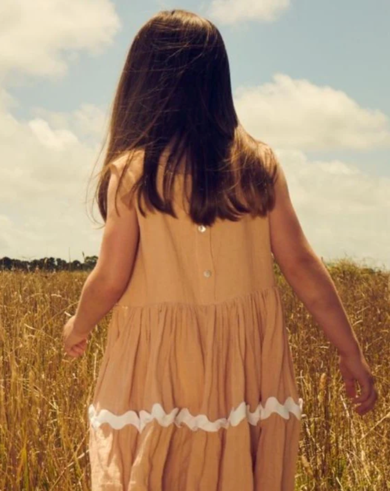 Girls cotton rick-rack dress in coral pink with tiered design and sleeveless fit | Dream Nu