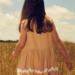 Girls cotton rick-rack dress in coral pink with tiered design and sleeveless fit | Dream Nu