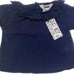 Front view of baby girl navy lace top with delicate detailing