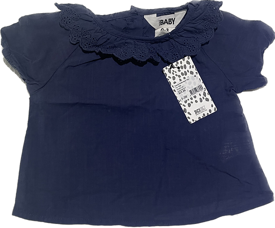 Front view of baby girl navy lace top with delicate detailing