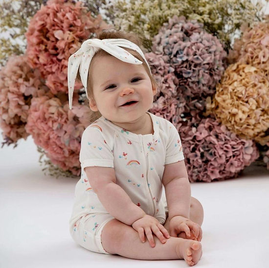 Front view of baby rainbow short romper with headband in soft organic cotton by Indigo & Lellow.
