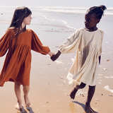 A dreamy, neutral-toned cotton dress for girls, designed with a relaxed fit and elegant draped sleeves for timeless charm and comfort | Dream Nu