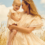 Close-up of a floral baby romper dress highlighting the intricate crochet trim and soft cotton fabric | Dream Nu