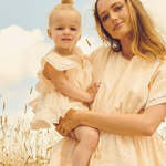 A soft floral baby romper dress with ruffled sleeves and delicate crochet trim, made from 100% cotton | Dream Nu