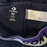 Side detail showing Converse logo on black leggings for girls