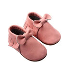 Pink baby moccasins with soft leather bow and fringe details