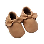 Pink fringe baby moccasins made from soft leather with bow