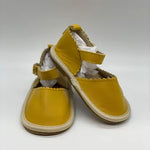 White polka dot leather sandals for girls on display