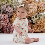 Front view of the Taylor Flora organic baby romper with floral design