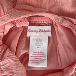 Close-up of stitching and fabric on blush cross-back top