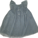 Close-up of glittery fabric and stitching on baby girl’s sparkle dress