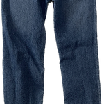 Close-up of waistband and button on blue skinny jeans